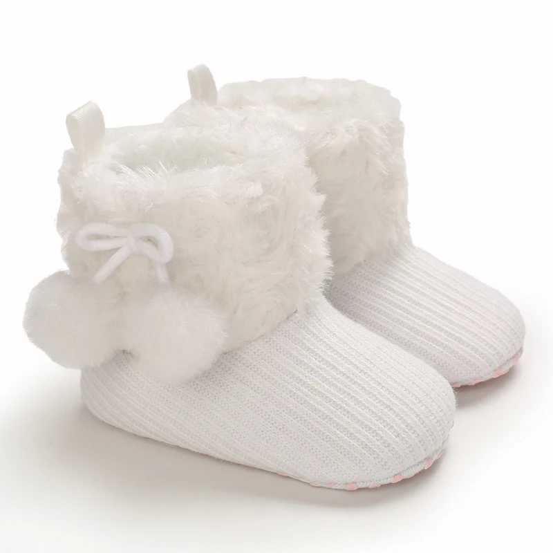 Chaussons bébé en laine avec pompons